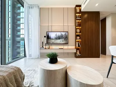 a living room with a tv and a table at Trophy-Live in Style Artistic Flair Unit in Dubai