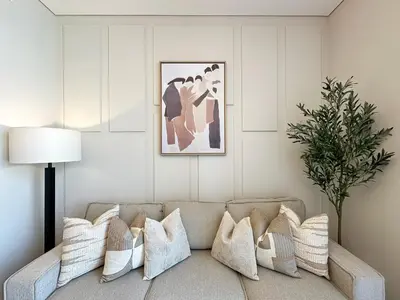 a living room with a couch with pillows at Trophy-Live in Style Artistic Flair Unit in Dubai