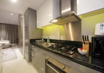 a kitchen with a stove and a sink at Dubai Dreams Pool & Canal View at Prive in Dubai