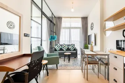 a living room with a couch and a table at Fully-equipped 1-br in Dubai Hills great amenities in Dubai