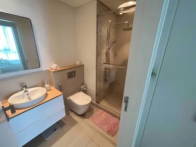 a bathroom with a toilet and a sink and a shower at Fully-equipped 1-br in Dubai Hills great amenities in Dubai