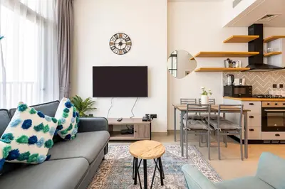 a living room with a couch and a table at Fully-equipped 1-br in Dubai Hills great amenities in Dubai
