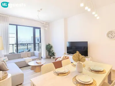 a living room with a couch and a table at HiGuests - La Rive Living Classy 2BR with Balcony in Dubai