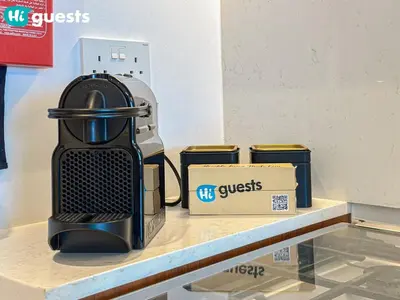a coffee maker sitting on a counter next to a box at HiGuests - La Rive Living Classy 2BR with Balcony in Dubai