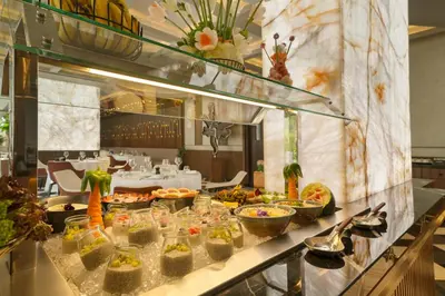 a buffet line with food on a table in a restaurant at Mileo Hotel The Palm in Dubai