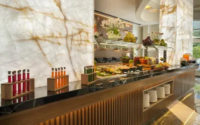 a buffet line with food on display in a hotel at Mileo Hotel The Palm in Dubai