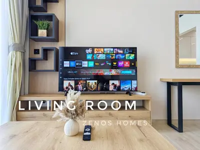 a living room with a flat screen tv on a wall at Modern Luxury Fully Furnished 1BH Apartment in Binghatti Luna JVC - Easy Access to JBR, Circle Mall & Dubai Hills Mall in Dubai