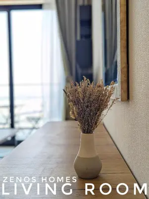 a vase with dried flowers sitting on a table at Modern Luxury Fully Furnished 1BH Apartment in Binghatti Luna JVC - Easy Access to JBR, Circle Mall & Dubai Hills Mall in Dubai