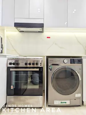 a kitchen with a stove and a microwave at Modern Luxury Fully Furnished 1BH Apartment in Binghatti Luna JVC - Easy Access to JBR, Circle Mall & Dubai Hills Mall in Dubai