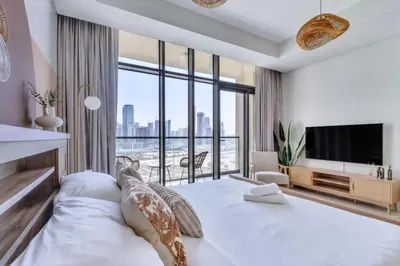 a bedroom with a large bed with a large window at GuestReady - Luxury Oasis in Business Bay in Dubai