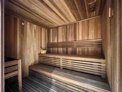 a wooden sauna with a bench in a room at GuestReady - Luxury Oasis in Business Bay in Dubai