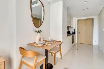 a dining room with a table and chairs and a mirror at GuestReady - Luxury Oasis in Business Bay in Dubai