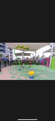 a playground with a slide in a park at Modern 2 BDR Apartment in Business Bay, Ocean & Burj AlArab Stunning View in Dubai