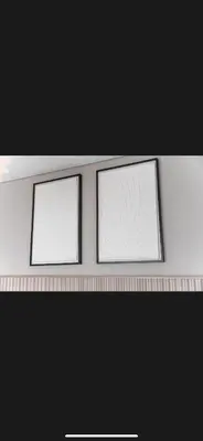two picture frames sitting on top of a shelf at Modern 2 BDR Apartment in Business Bay, Ocean & Burj AlArab Stunning View in Dubai