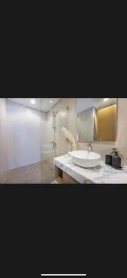 a bathroom with a sink and a glass shower at Modern 2 BDR Apartment in Business Bay, Ocean & Burj AlArab Stunning View in Dubai