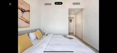 a small bedroom with a bed with a white bedspread at Luxurious Downtown Views 2 bedrooms holiday home in Dubai