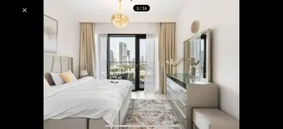 a white bedroom with a bed and a balcony at Luxurious Downtown Views 2 bedrooms holiday home in Dubai