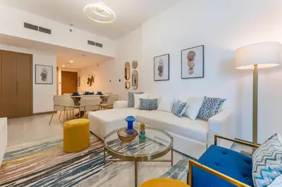 a living room with a white couch and a table at Upscale 1BR Luxury Apt in Business Bay in Dubai