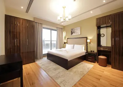 a bedroom with a bed and a large window at Downtown Dubai Stay in 2BR Chic Elite Apartment in Dubai