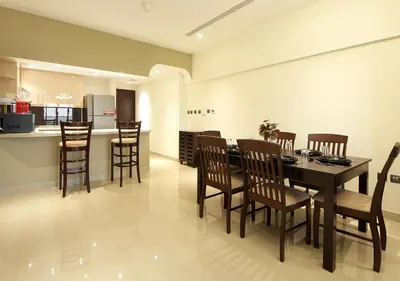 a dining room and kitchen with a table and chairs at Downtown Dubai Stay in 2BR Chic Elite Apartment in Dubai