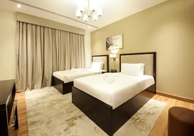 a hotel room with two beds and a window at Downtown Dubai Stay in 2BR Chic Elite Apartment in Dubai