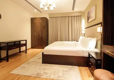 a bedroom with a bed and a desk in a room at Downtown Dubai Stay in 2BR Chic Elite Apartment in Dubai