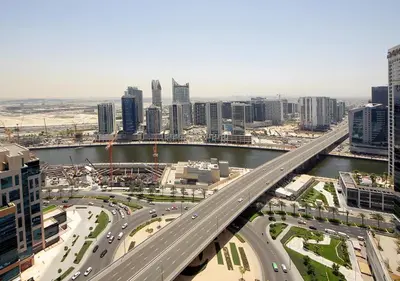 an overhead view of a city with a bridge at Downtown Dubai Stay in 2BR Chic Elite Apartment in Dubai