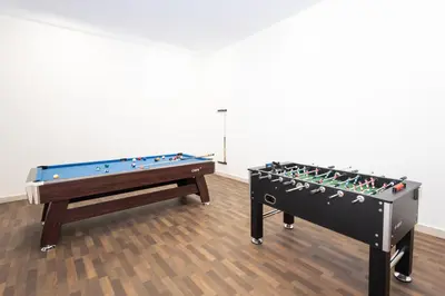 two snooker tables next to each other in a room at Spacious 2BR Apartment l Rooftop Pool l Gym in Dubai