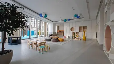 a living room with a table and chairs and a tree at Luxury 4BR Full Burj khalifa & Fountain View, 1Gbps, PS5 in Dubai