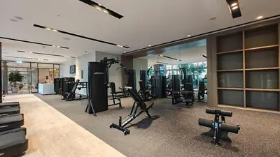 a gym with a lot of exercise equipment in it at Luxury 4BR Full Burj khalifa & Fountain View, 1Gbps, PS5 in Dubai