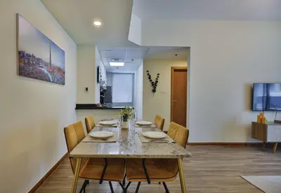 a dining room with a table and chairs at Near Metro Station - 1BR in Marina Diamond 3, Dubai Marina - Allsopp & Allsopp in Dubai