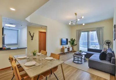 a living room with a table and a couch at Near Metro Station - 1BR in Marina Diamond 3, Dubai Marina - Allsopp & Allsopp in Dubai