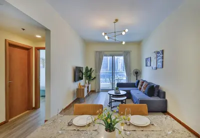 a living room with a blue couch and a table at Near Metro Station - 1BR in Marina Diamond 3, Dubai Marina - Allsopp & Allsopp in Dubai