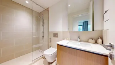 a bathroom with a toilet and a sink and a shower at FAM Living - Modern 1BR at Orchid, Creek Harbour in Dubai