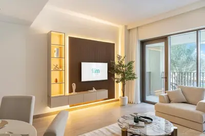 a living room with a couch and a tv at FAM Living - Modern 1BR at Orchid, Creek Harbour in Dubai
