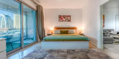 a bedroom with a bed and a large window at 8min Walk from JBR beach Stylish 1-Bedroom Apartment in Dubai Marina in Dubai