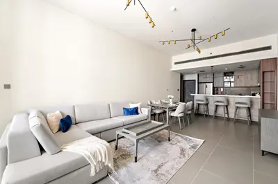 a living room with a couch and a table at Stylish 2BR in Royal MBL in Dubai