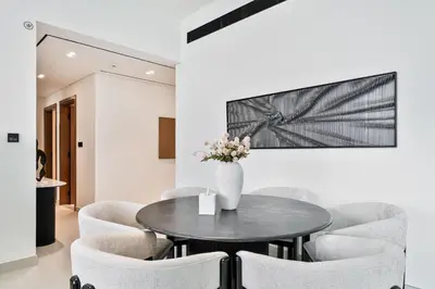 a dining room with a table and chairs at Vibrant - 2BR - Exclusive Pool, Shared Gym in Dubai