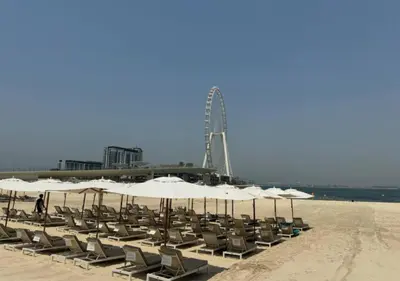 a bunch of chairs and umbrellas on a beach at Modern Stay at The Address JBR in Dubai