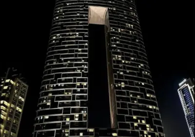 a tall building at night with lights on it at Modern Stay at The Address JBR in Dubai