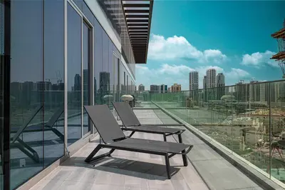 two chairs on a balcony with a view of a city at Stylish 1BR with Spacious Terrace Near Circle Mall in Dubai