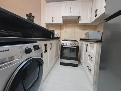 a kitchen with a washer and dryer in it at super Luxurious Apartment Downtown Dubai Mall burj khalifa DIFC in Dubai