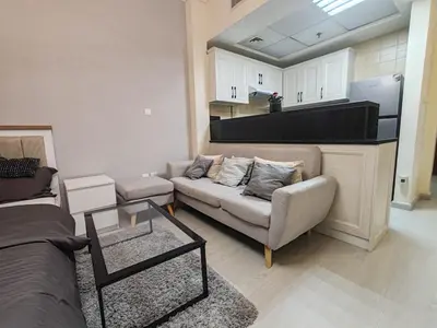 a living room with a couch and a kitchen at super Luxurious Apartment Downtown Dubai Mall burj khalifa DIFC in Dubai