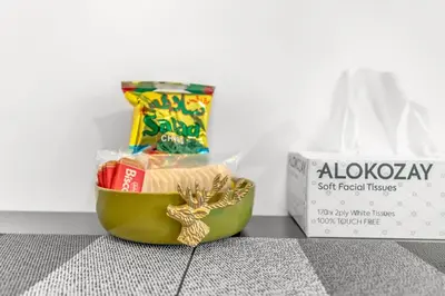 a green bowl with food in it next to a box at super Luxurious Apartment Downtown Dubai Mall burj khalifa DIFC in Dubai
