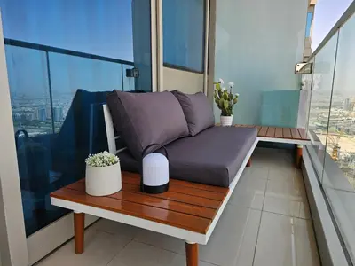a couch sitting on a table on a balcony at New Renovated Stylish 1 Br Dubai View 73 Floor in Dubai