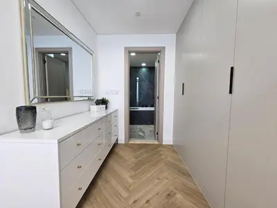 a white bathroom with a sink and a mirror at New Renovated Stylish 1 Br Dubai View 73 Floor in Dubai
