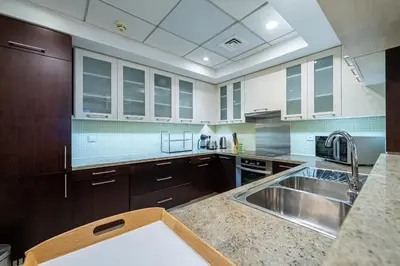a large kitchen with a sink and a counter at Spacious 2 bedroom apartment in Downtown Dubai in Dubai