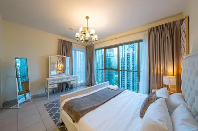 a bedroom with a bed and a large window at Spacious 2 bedroom apartment in Downtown Dubai in Dubai