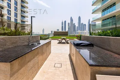 a kitchen with a sink and a view of the city at Emaar Beachfront - Sunrise Bay Tower 1, Dubai Marina in Dubai