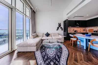 a living room with a couch and a table at Emaar Beachfront - Sunrise Bay Tower 1, Dubai Marina in Dubai